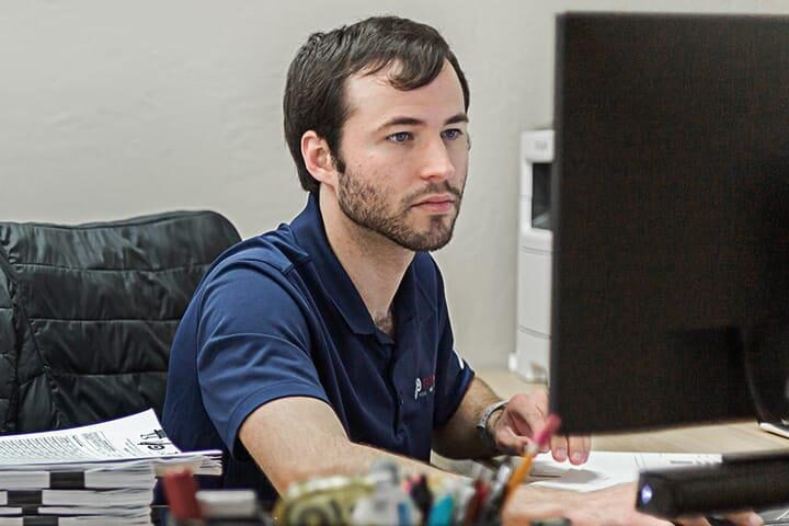 Probata employee at desk looking at computer