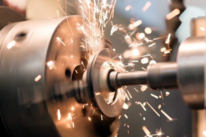 metal drilling equipment spinning against metal with sparks flying