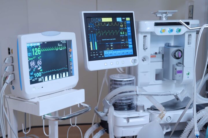 Medical computer equipment with vitals and graphs on screens