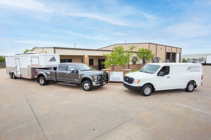 Exterior view of the Probata office with a Probata van and Mobile Calibration trailer attached to a heavy-duty truck.