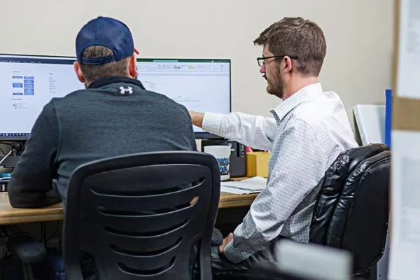 Probata employees at computer looking at test data